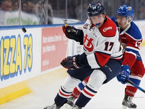 Edmonton's Nick Bowman (13) battles Lethbridge's Josh Tarzwell (17) during the third period of a game game between the Edmonton Oil Kings and the Lethbridge Hurricanes at Rogers Place in Edmonton on Friday, September 29, 2017.