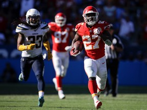 In this Sept. 24, 2017, file photo, Kansas City Chiefs running back Kareem Hunt, right, runs for a touchdown against the Los Angeles Chargers during the second half of an NFL football game in Carson, Calif. Hunt was the AFC offensive player of the month after he led the league with 401 yards rushing, caught nine passes for 137 yards and reached the end zone five times. The Chiefs face the Washington Redskins this week. (AP Photo/Jae C. Hong, File)