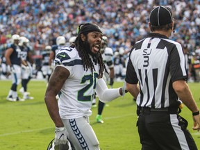 Seahawks cornerback Richard Sherman (left) argues with a referee during NFL action against the Titans in Nashville, Tenn., on Sept. 24, 2017. (Austin Anthony/Daily News via AP)