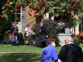 A couple watches from across the street as The Chachkies warm up before the start of Porchfest on Saturday September 30, 2017 in Belleville, Ont. Tim Miller/Belleville Intelligencer/Postmedia Network