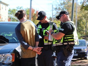 Around 11,000 people packed Broughdale Avenue and nearby streets for an unsanctioned Western University Homecoming party Saturday. (DALE CARRUTHERS, The London Free Press)