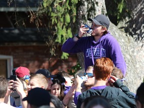Around 11,000 people packed Broughdale Avenue and nearby streets for an unsanctioned Western University Homecoming party Saturday. (DALE CARRUTHERS, The London Free Press)