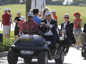 Donald Trump drives himself around the golf course to watch the final round of the Cadillac Championship golf tournament in Doral, Fla., on March 6, 2016. (Luis Alvarez/AP Photo/Files)