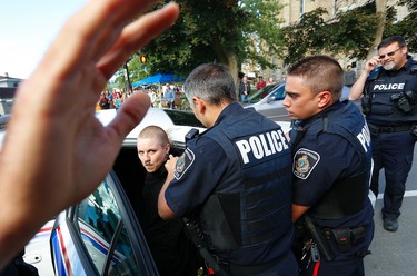 Tensions rise as city police escort a protestor to a police vehicle during a White Supremacy demonstration on Saturday September 30, 2017 on George St. in Peterborough, Ont. CLIFFORD SKARSTEDT/PETERBOROUGH EXAMINER/POSTMEDIA NETWORK