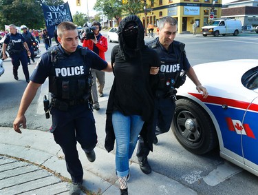 Tensions rise as city police escort a protestor to a police vehicle during a White Supremacy demonstration on Saturday September 30, 2017 on George St. in Peterborough, Ont. CLIFFORD SKARSTEDT/PETERBOROUGH EXAMINER/POSTMEDIA NETWORK