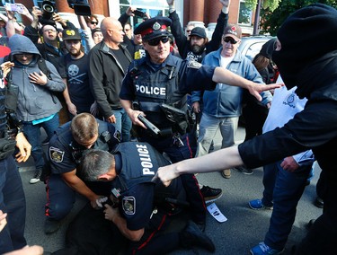 Tensions rise as city police deal with a protestor during a White Supremacy demonstration on Saturday September 30, 2017 on George St. in Peterborough, Ont. CLIFFORD SKARSTEDT/PETERBOROUGH EXAMINER/POSTMEDIA NETWORK