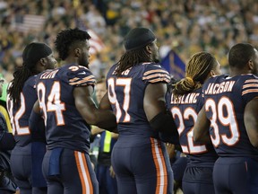 Bears players link arms during the national anthem before an NFL game against the Packers in Green Bay, Wis., on Thursday, Sept. 28, 2017. (Morry Gash/AP Photo)