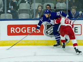 Maple Leafs right wing Nikita Soshnikov (left) is checked by Red Wings defenceman Xavier Ouellet (right) during first period NHL preseason action in Toronto on Saturday, Sept. 30, 2017. (Christopher Katsarov/The Canadian Press)