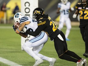 Argonauts wide receiver DeVier Posey (left) makes a touchdown catch during CFL overtime action against the Tiger-Cats in Hamilton, Ont. on Saturday, Sept. 30, 2017. (Peter Power/The Canadian Press)