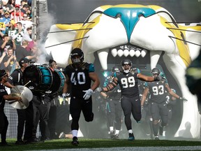 Jaguars defensive tackle Eli Ankou (99) reacts as he and teammates run onto the field before an NFL game against the Ravens at Wembley Stadium in London on Sept. 24, 2017. (AP Photo/Matt Dunham)