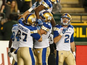 Winnipeg's Clarence Denmark (89) celebrates a touchdown with teammates during the first half against the Eskimos on Saturday night. (Ian Kucerak/Postmedia Network)