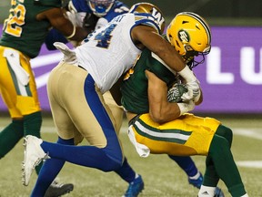 Edmonton's Brandon Zylstra (83) is tackled by Winnipeg's Jackson Jeffcoat (94) during the first half of a CFL football game between the Edmonton Eskimos and the Winnipeg Blue Bombers at Commonwealth Stadium in Edmonton, Alberta on Saturday, September 30, 2017