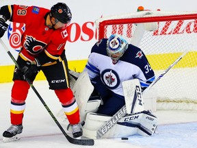 Calgary Flames Micheal Ferland attempts to redirect a puck past goalie Steve Mason of the Winnipeg Jets during NHL pre-season hockey at the Scotiabank Saddledome in Calgary on Saturday, September 30, 2017. (Al Charest/Postmedia Network)