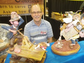 Mark Sheridan of the Ontario Wood Carvers Association with his work at the WoodStock Woodworking Show Friday. (HEATHER RIVERS/SENTINEL-REVIEW)