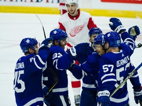 Toronto Maple Leafs defenceman Travis Dermott (57) celebrates a goal with teammates in the third period of NHL pre-season hockey action in Toronto on Saturday, September 30, 2017. (THE CANADIAN PRESS/Christopher Katsarov)