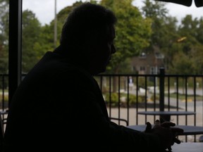 Durham Regional Police Sgt. Tom Andrews is pictured in silhouette while talkinjg with Toronto Sun columnist Michele Mandel.(JACK BOLAND, Toronto Sun)