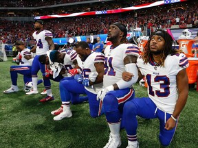 Bills players take a knee during the U.S. national anthem before a NFL game against the Falcons in Atlanta on Sunday, Oct. 1, 2017. (John Bazemore/AP Photo)