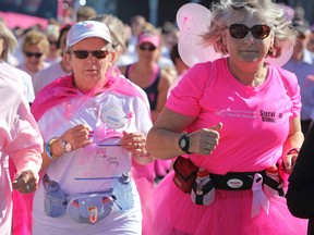 Cancer survivors dressed in pink take part in the Survivors Walk to open the Run for the Cure at St. Lawrence College on Sunday morning. (Steph Crosier/The Whig-Standard)