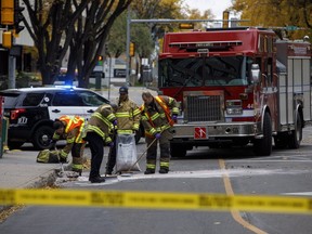 Crews clean up the scene where a cube van ran into pedestrians and later flipped over while being pursued by police, in Edmonton Alta, on Sunday, Oct. 1, 2017. (THE CANADIAN PRESS/Jason Franson)