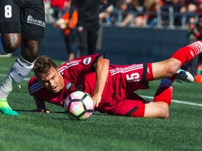 Ottawa Fury’s Nick DePuy can only watch from ground level as a Charleston opponent takes off with the ball in Sunday’s 1-1 tie at TD Place. (Ashely Fraser/Postmedia Network)
