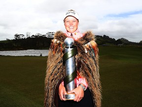 Brooke Henderson of Canada poses with the New Zealand Women's Open trophy by MC Kim during day five of the New Zealand Women's Open at Windross Farm on October 2, 2017 in Auckland, New Zealand. (Hannah Peters/Getty Images)