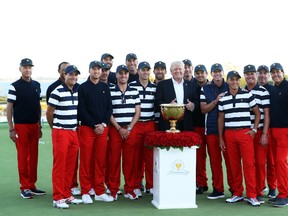 U.S. President Donald Trump poses with the U.S. Team and the trophy after they defeated the International Team 19 to 11 in the Presidents Cup at Liberty National Golf Club on October 1, 2017 in Jersey City, New Jersey. (Photo by Sam Greenwood/Getty Images)