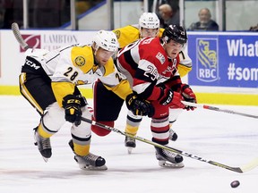 Sarnia Sting's Kelton Hatcher (28) battles Tye Felhaber (29) of the Ottawa 67's at Progressive Auto Sales Arena in Sarnia, Ont., on Sunday, Oct. 1, 2017. (Mark Malone/Chatham Daily News/Postmedia Network)