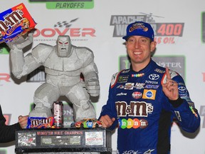 Kyle Busch, driver of the #18 M&M's Caramel Toyota, poses with the trophy in Victory Lane after winning the Monster Energy NASCAR Cup Series Apache Warrior 400 presented by Lucas Oil at Dover International Speedway on October 1, 2017 in Dover, Delaware. (Photo by Chris Trotman/Getty Images)