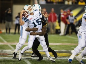 Toronto Argonauts quarterback Ricky Ray (15) is sacked from behind by Hamilton Tiger-Cats defensive end Adrian Tracy (5) during first-half CFL Football action in Hamilton, Ont. on Saturday, September 30, 2017. THE CANADIAN PRESS/Peter Power