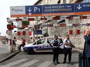 French police officers patrol outside the Marseille railway station, Sunday, Oct. 1, 2017. French police warn people to avoid Marseille's main train station amid reports of knife attack, assailant shot dead. (AP Photo/Claude Paris)