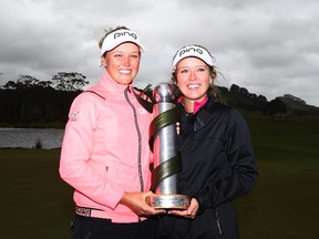 Brooke Henderson of Canada and her sister Brittany Henderson hold the New Zealand Women's Open trophy after winning the New Zealand Women's Open at Windross Farm on October 2, 2017 in Auckland, New Zealand. (Photo by Hannah Peters/Getty Images)