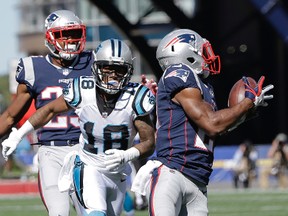 New England Patriots cornerback Malcolm Butler, foreground, intercepts a pass intended for Carolina Panthers wide receiver Damiere Byrd (18) during the first half of an NFL football game, Sunday, Oct. 1, 2017, in Foxborough, Mass. (AP Photo/Steven Senne)