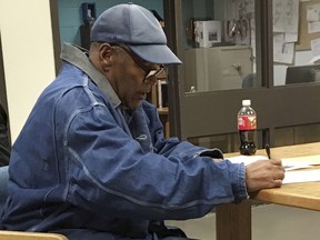 This image released by the Nevada Department of Corrections shows O.J. Simpson signing documents and leaving Lovelock Correctional Centre in Lovelock, Nevada, early on October 1, 2017. (AFP PHOTO / Nevada Department of Corrections)