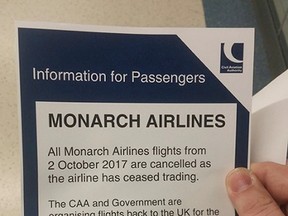 In this image provided by Simon Stirrat, a notice for Monarch Airlines passengers is seen at London's Gatwick Airport, Monday, Oct. 2, 2017. Troubled British carrier Monarch Airlines has suspended flights after failing to resolve its financial woes. The airline, the country's fifth largest, stopped trading on Monday, warning travelers it had ceased operations. (Simon Stirrat via AP)