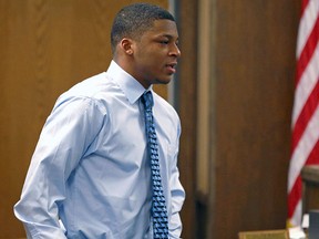 In this March 17, 2013, file photo, Ma'lik Richmond walks toward the victim and her family to apologize after he and co-defendant Trent Mays were found delinquent on rape and other charges during their trial in juvenile court in Steubenville, Ohio. (AP Photo/Keith Srakocic, Pool, File)