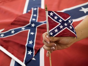 An employee holds up a Confederate flag during the manufacturing process at the Alabama Flag and Banner on April 12, 2016 in Huntsville, Alabama. (Ty Wright/Getty Images)