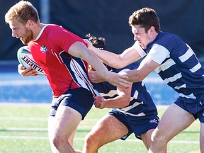 Belleville native and Moira S.S. graduate Wade Little tries to evade a pair of U of T defenders during OUA men's rugby action last weekend in Toronto. Little's Brock Badgers were victorious. (Brock Athletics photo)