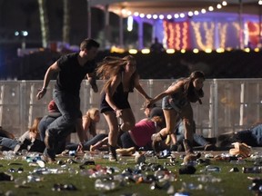People run from the Route 91 Harvest country music festival after apparent gun fire was heard on October 1, 2017 in Las Vegas, Nevada. There are reports of an active shooter around the Mandalay Bay Resort and Casino.  (Photo by David Becker/Getty Images)