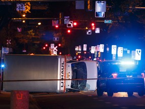 An overturned U-Haul truck is seen on 100 Avenue near 106 Street after Edmonton Police Service officers arrested a man who attacked a police officer outside of an Edmonton Eskimos game at 92 Street and 107A Avenue in Edmonton, Alberta on Sunday, October 1, 2017. (Ian Kucerak/Postmedia Network)