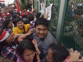 Indonesian supporters of Jakarta governor Basuki Tjahaja Purnama, also know as Ahok, push a gate at the Cipinang Prison where Jakarta governor Basuki Tjahaja Purnama is being prisoned in Jakarta on May 9, 2017. Jakarta's Christian governor was jailed for two years on May 9 after being found guilty of blasphemy, in a shock decision that has stoked concerns over rising religious intolerance in the world's most populous Muslim-majority nation. / AFP PHOTO / ADEK BERRYADEK BERRY/AFP/Getty Images  INDONESIA-RELIGION-TRIAL-ISLAM