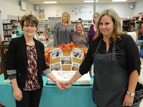 Twice is Nice manager Shauna Bruneau (left) and Wellspring executive director Becky Wells cut the cake for the store’s first anniversary at Midtown Mall on Sept. 30 (Peter Shokeir | Whitecourt Star).