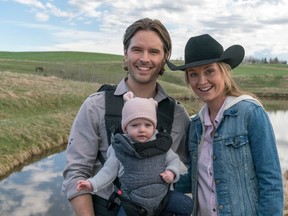 London?s Amber Marshall poses with her onscreen husband Graham Wardle and a baby girl on the set of Heartland. (Andrew Bako/Special to Postmedia News)