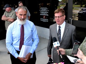 Kevin Jakubec, left, spokesperson for Water Wells First, and his lawyer, Mark MacKew, speak to local media in Chatham, Ont. on Monday, October 2, 2017, after North Kent Wind, owned by Korean industrial giant Samsung, and its American partner Pattern Energy, were successful in obtaining an injunction banning any protest activities that block or otherwise interfere with construction of the 100-megawatt wind farm in north Chatham-Kent. (Ellwood Shreve/Chatham Daily News)