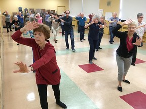 Members of the Kingston Seniors Centre take part in a tai chi class down the hall from where the results of the annual Vital Signs report from the Community Foundation for Kingston and Area were being released in Kingston, Ont. on Monday, Oct. 2, 2017. 
Elliot Ferguson/The Whig-Standard/Postmedia Network