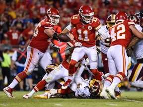 Quarterback Alex Smith #11 of the Kansas City Chiefs tries to run through the sack attempt of free safety D.J. Swearinger #36 of the Washington Redskins during the third quarter of the game at Arrowhead Stadium on October 2, 2017 in Kansas City, Missouri. (Jason Hanna/Getty Images )