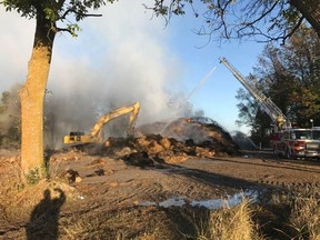 Firefighters were still on the scene Tuesday morning after working all night on a fire that broke out in a Kinburn-area coverall structure that housed 1,600 round bails of hay.