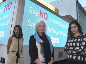 Zina Rakhamilova, from left, Meryle Kates, executive director of StandWithUs Canada, and Shanel Jacobs post with their truck declaring "Say No to Roger Waters and Israel Boycotts" on Monday, October 2, 2017. (Toronto Sun staff)
