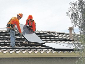 Solar panels are installed on a home's roof.
Matt York/Associted Press Files