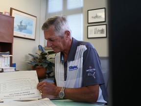 Jason Miller/The Intelligencer
City treasurer, Brian Cousins, reviews some paperwork at his city hall office on Tuesday.