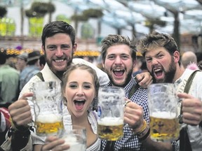 Revellers in Munich, Germany, raise their mugs to Oktoberfest. (Special to Postmedia News)